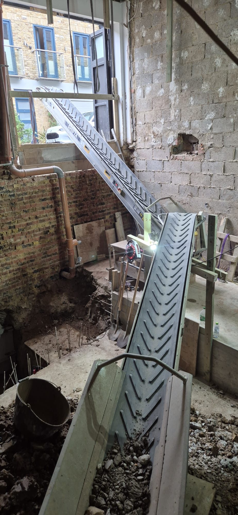 Conveyor carrying spoil out through the front
