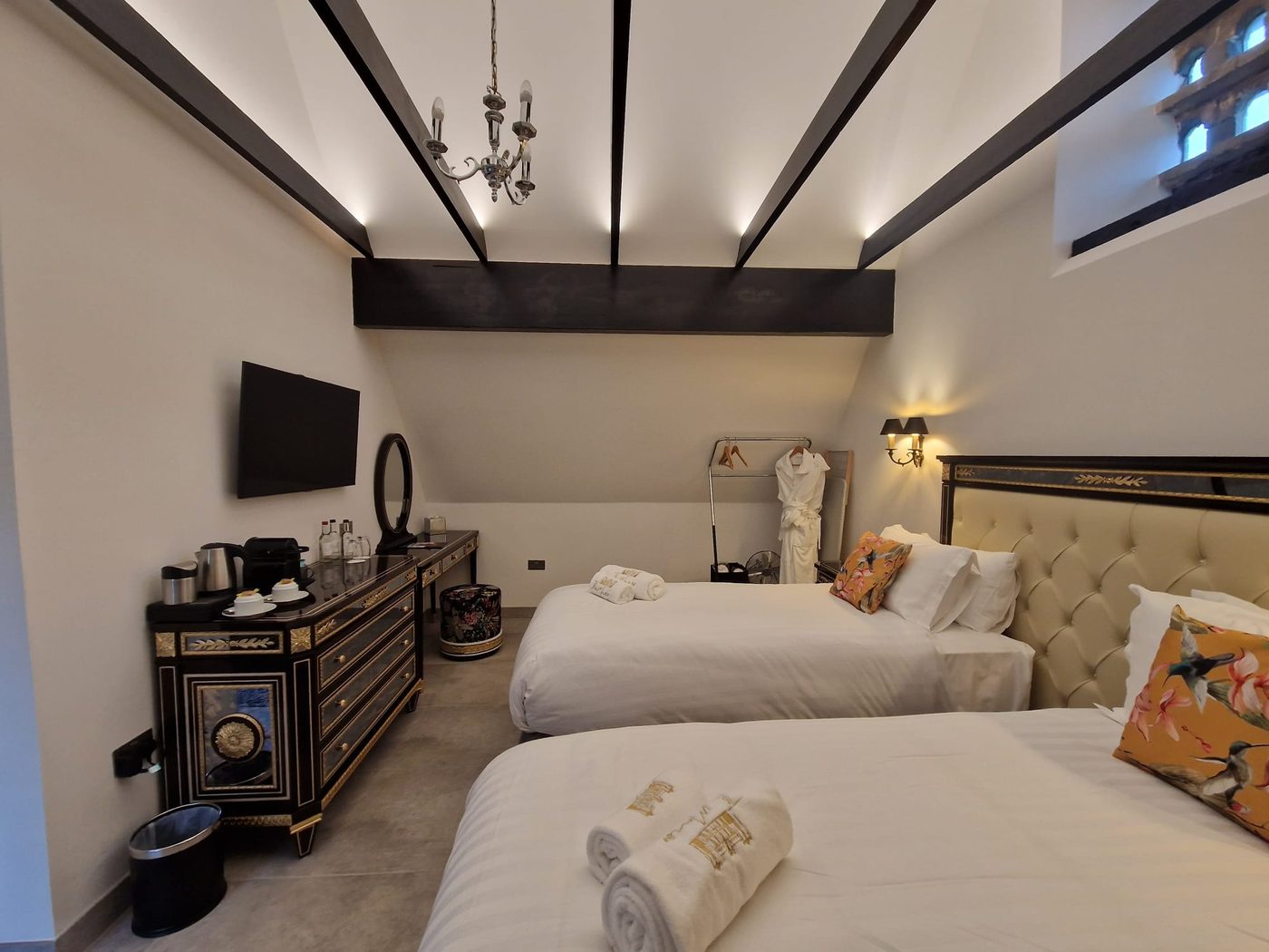 Refurbished hotel bedroom with exposed beams