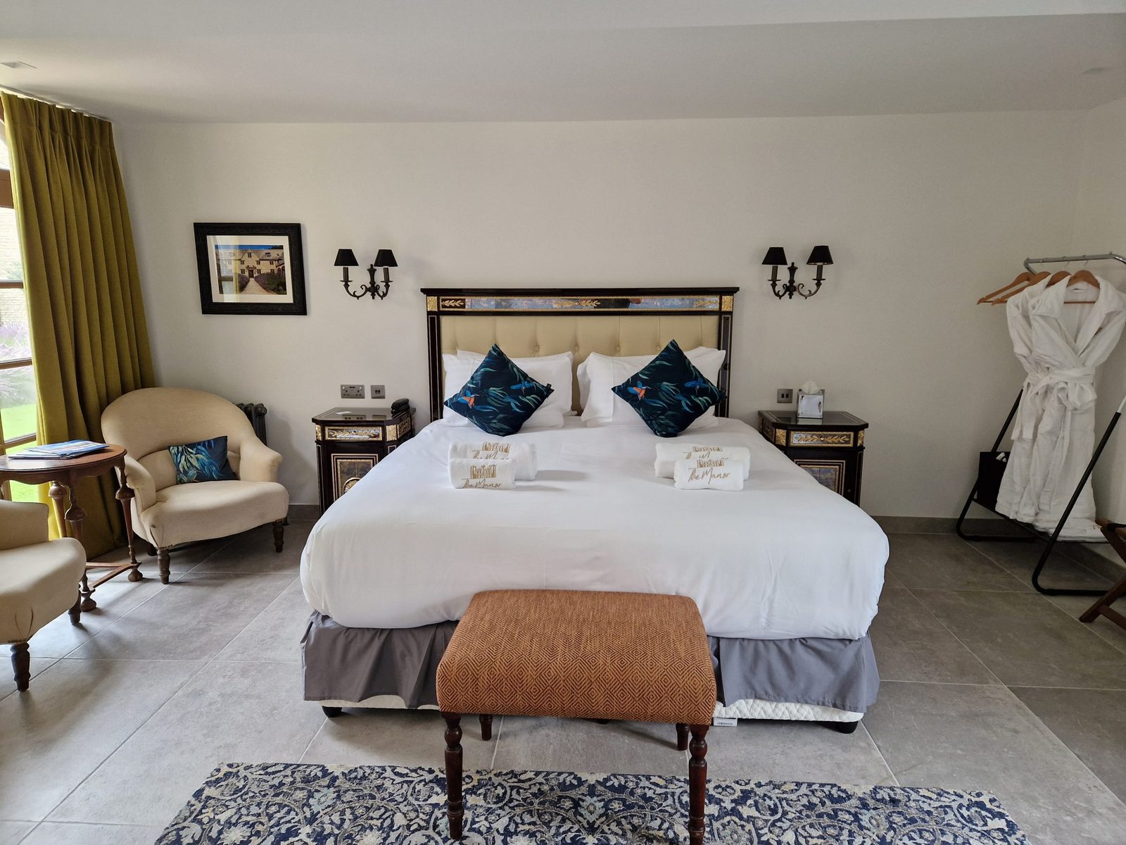 Hotel bedroom with a bench at the foot of the bed